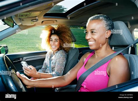 Mother driving car, daughter passenger hi-res stock photography and