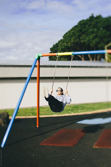 Woman Swinging On A Playground By Stocksy Contributor Andrey Pavlov