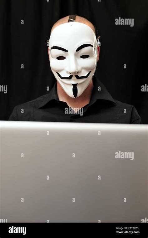 Member Of The Anonymous Hacker Group In Front Of The Laptop Stock