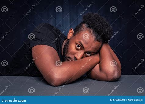 Handsome Black Man With Head On Arms Looking Up Stock Image Image Of