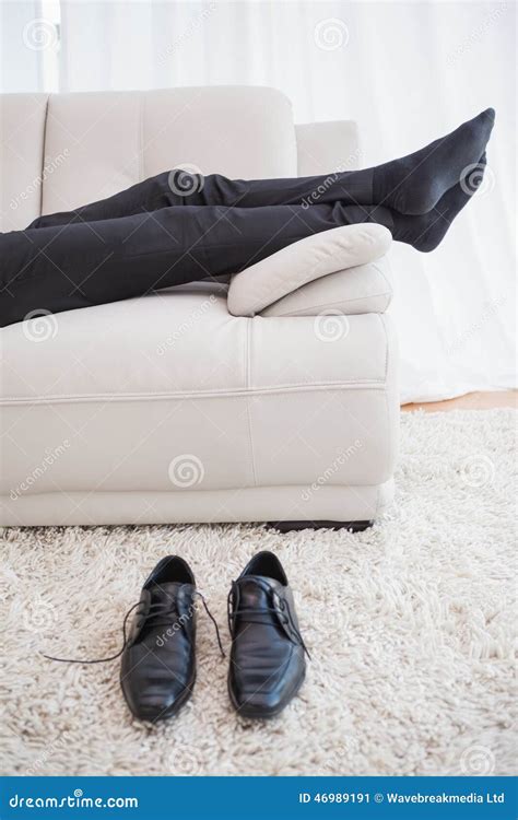 Businessman Lying On Couch Legs Only Visible Stock Image Image Of