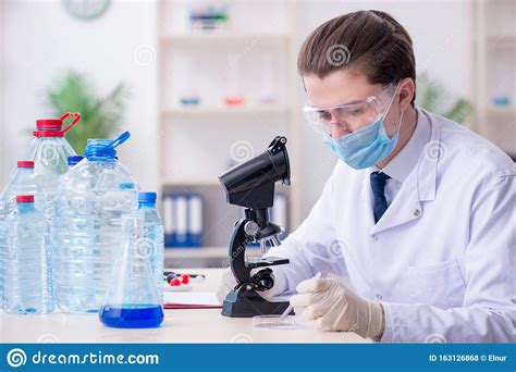 Young Male Chemist Experimenting In Lab Stock Photo Image Of Microbes