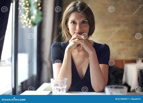 Young Woman Sitting At A Restaurant Table Stock Image Image Of Elegant Girl 67495817