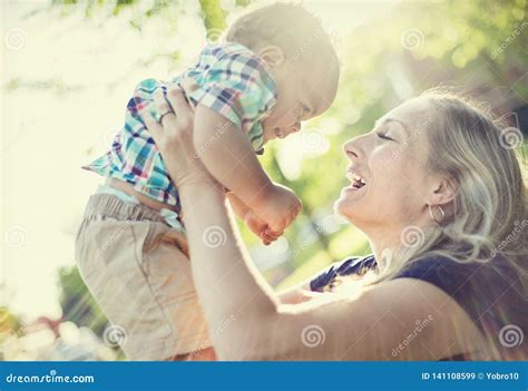 Beautiful Mother Holding Her Adorable Baby Boy In The Sunset Sunlight Stock Image Image Of
