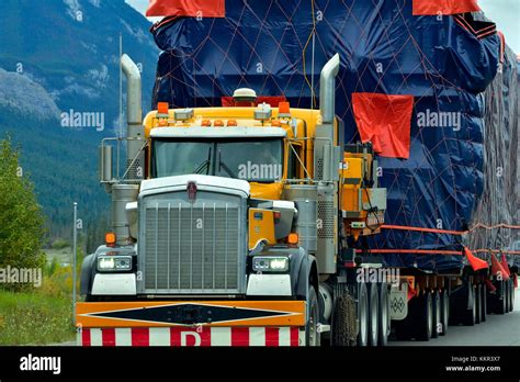 A Close Up Of A Semi Truck With An Oversize Load Traveling On An