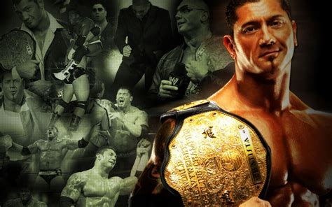 A Man Holding A Wrestling Belt In Front Of An Image Of Many Other Men