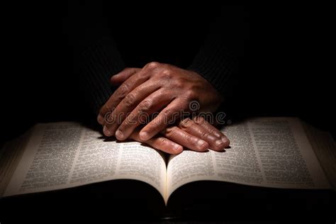Praying Hands Over Bible