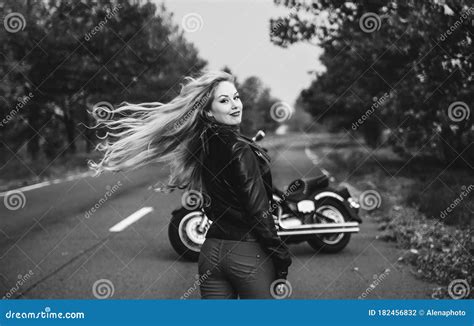 Black And White Photo Of Beautiful Biker Women Posing With Motorcycle
