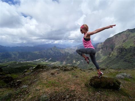 Young Happy Woman Jumping On Top Of The Mountain Stock Image Image Of
