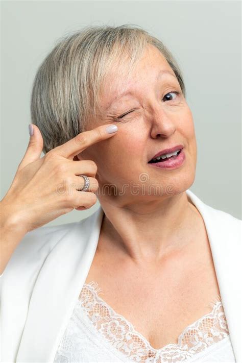 Face Shot Of Middle Age Woman Pointing With Finger At Crow`s Feet On Face Stock Image Image Of