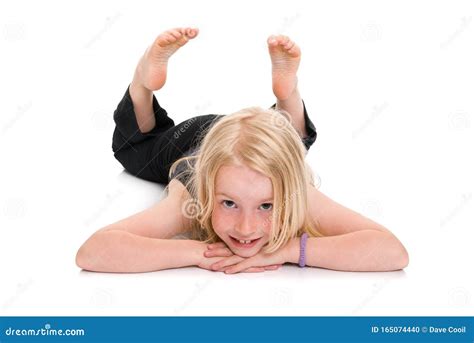Young Blonde Girl Lying On Floor And Smiling Isolated On White Stock