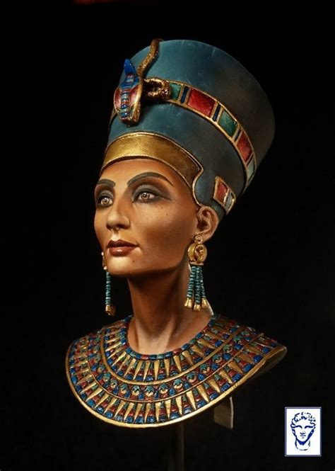 the bust of an egyptian woman with blue and gold jewelry on it s head