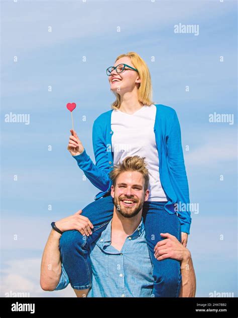 Man Carries Girlfriend On Shoulders Sky Background Couple Happy Date