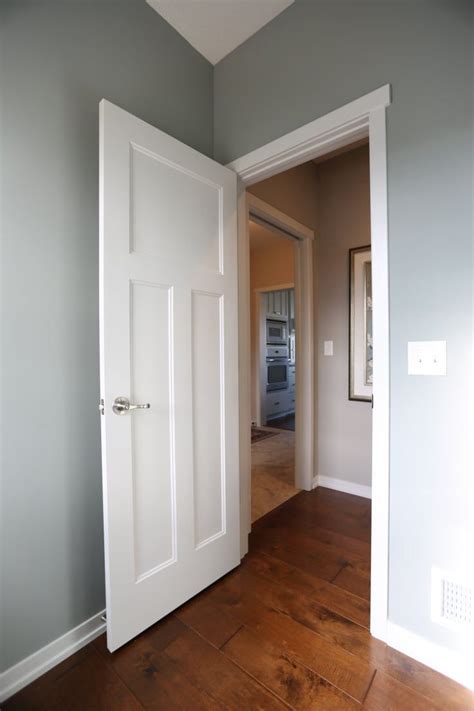 Interior Doors | white molded 3 panel door against a blue ...