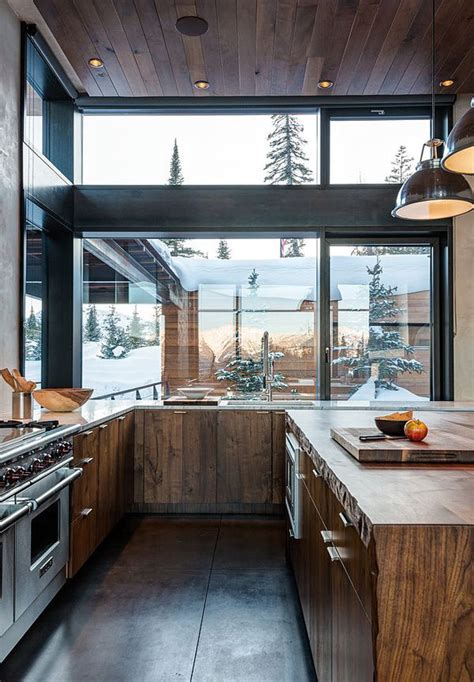 Make it luxury with the smooth concrete cabinets and some ceiling lights to brighten the area. modern-rustic-kitchen-with-glass-window | HomeMydesign