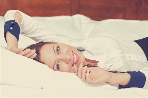 Cheerful Woman Lying On The Bed At Home Daydreaming Resting Stock Photo