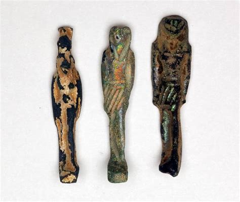 A Group Of 3 Egyptian Iridescent Glass Deity Amulets