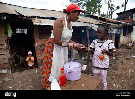 A Woman Sells Fried Potatoes At Her Open Stall In The Streets Of Gatina Kawangware Slum In