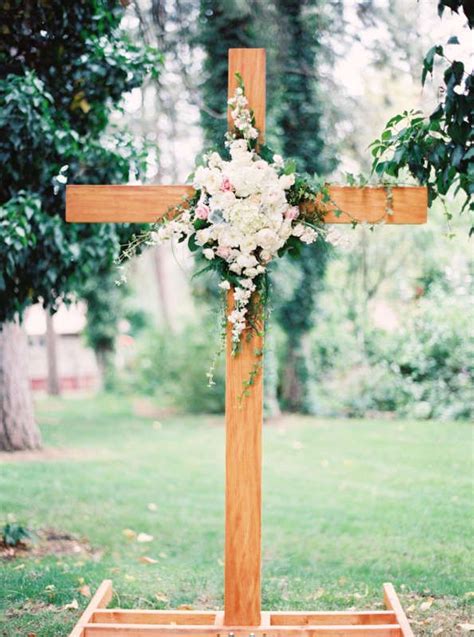 Lots of couples choose florals as the defining feature of their altar. DIY wooden altar decoration with flowers at a garden ...