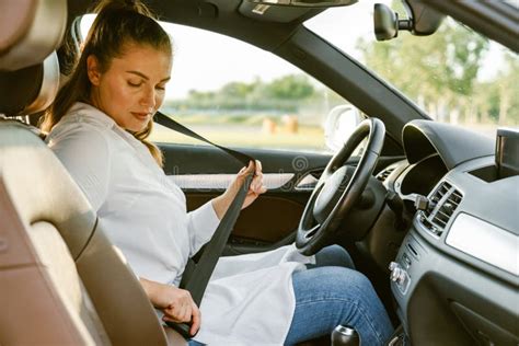 Young Woman Fastening Her Seat Belt While Sitting In Car Stock Image Image Of White Sitting