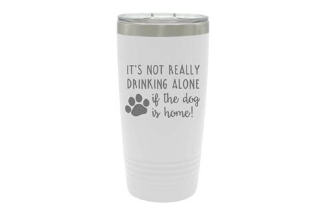 The mug features a clear lid and decorative rim around the top. It's not really drinking alone if the dog is home ...