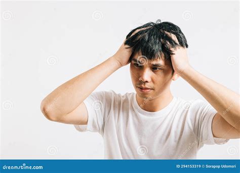 Asian Man Battling Stress And Throbbing Headache Holds Head With A