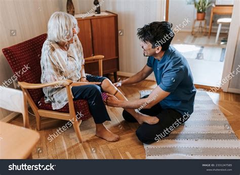 Male Care Assistant Helping Senior Woman Stock Photo 2331247585