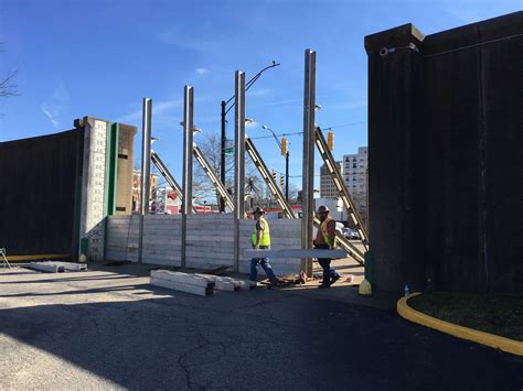 A flood wall (or floodwall) is a primarily vertical artificial barrier designed to temporarily contain the waters of a river or other waterway which may rise to unusual levels during seasonal or extreme weather events. Floodwall & Levees | Huntington Stormwater Utility