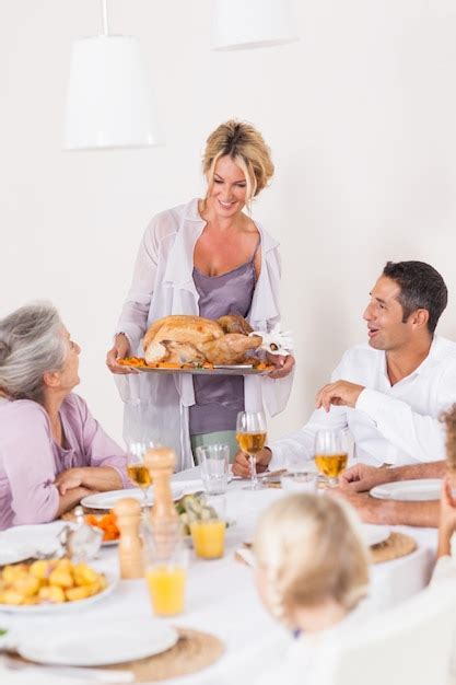 Premium Photo Mother Bringing Turkey To Dinner Table