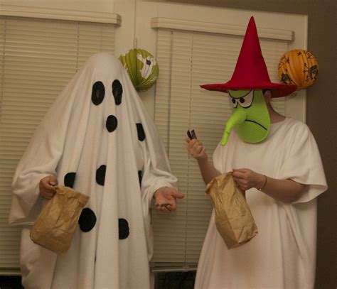 Two People Dressed Up In Costumes For Halloween