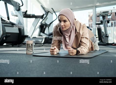 Horizontal Portrait Shot Of Sporty Young Adult Muslim Woman Wearing