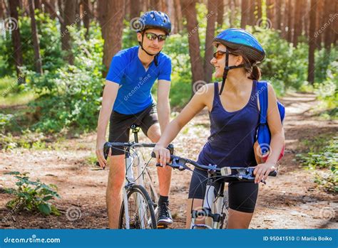Couple Riding A Bicycle In The Forest Stock Photo Image Of Male