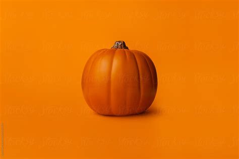 Pumpkin On A Solid Orange Background By Stocksy Contributor Austin