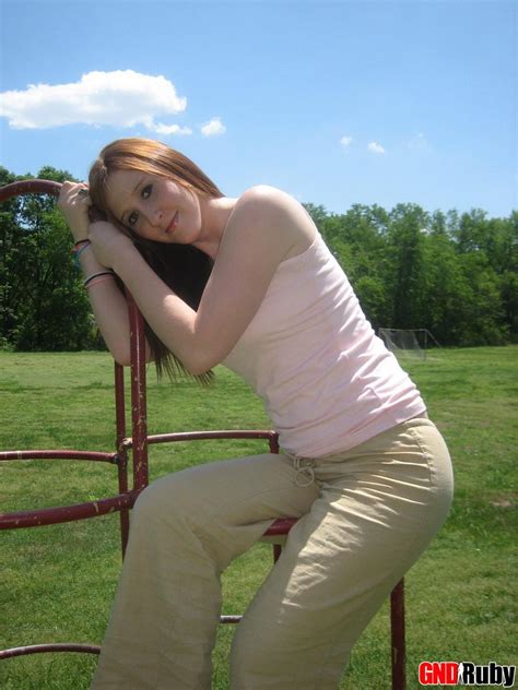 cute ginger teen ruby flashes her perky tits at the park while playing on the jungle gym porn
