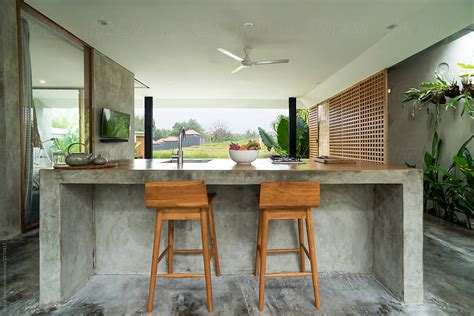 For centuries the kitchen was strictly a work space. Modern open kitchen in luxury villa, Bali by Bisual Studio - Kitchen, Living room - Stocksy United