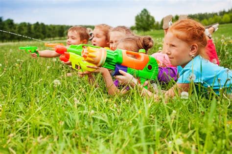Five Kids Play With Water Guns Stock Image Image Of Funny Dandelions