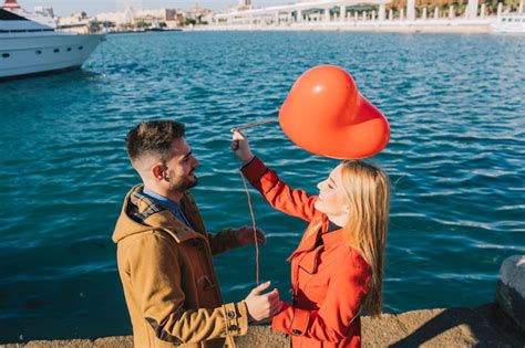 Free Photo Laughing Couple With Red Heart Balloon