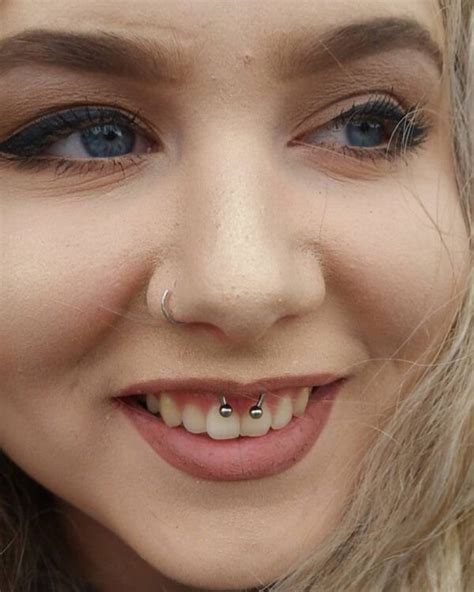 A Woman With Piercings On Her Nose Smiling