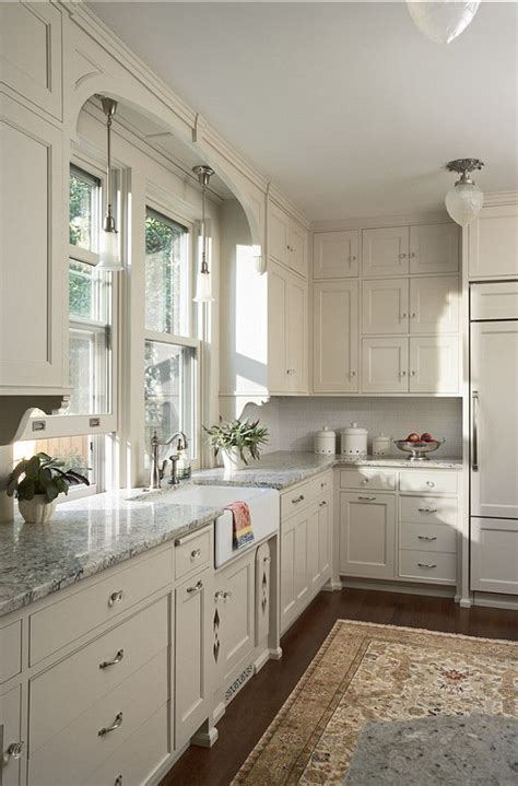 Bright, sunny kitchens with pastel trim or country curtains don't appeal to everyone, so if you have an edgier aesthetic, you might choose a darker route. White Kitchen Cabinets, Gray Granite Countertops, Dark Wood Floors, Persian Rug - Kitchen ...