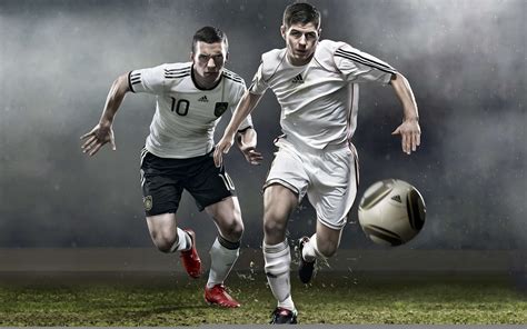 Two Soccer Players Chasing Ball In Field Hd Wallpaper Wallpaper Flare