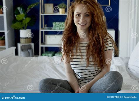Portrait Of Redhead Woman Sitting On Bed Stock Photo Image Of