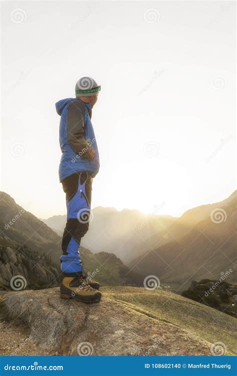 Hikers Looking At The Stunning Landscape In The Mountains During