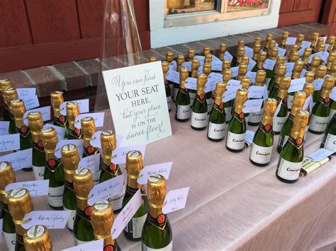 Mini Champagne Bottles As Escort Cards With Cute Sign Cloud 9 Weddings Champagne Wedding