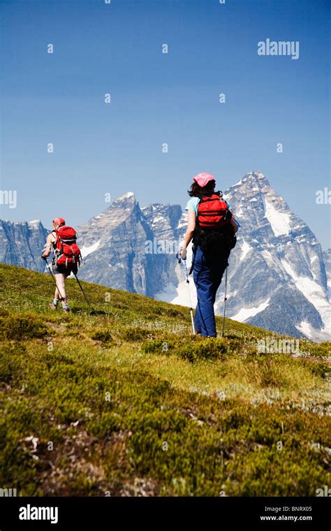 Two Female Hikers In The Selkirk Mountains With A View Of Mount Sir