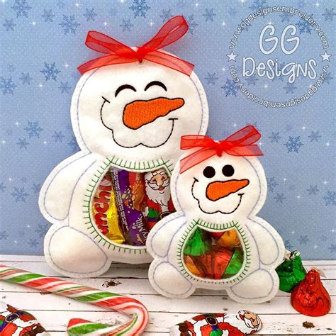 Two Stuffed Snowmen Are Next To Candy Canes