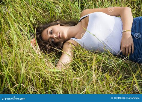 Smiling Brunette Laying On Grass In Sunlight Stock Photo Image Of