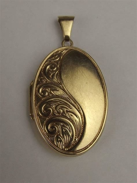 The locket is very eye catching with it's colour and leafy engraving on the front. 9ct Yellow Gold Oval Engraved Locket Pendant from ...