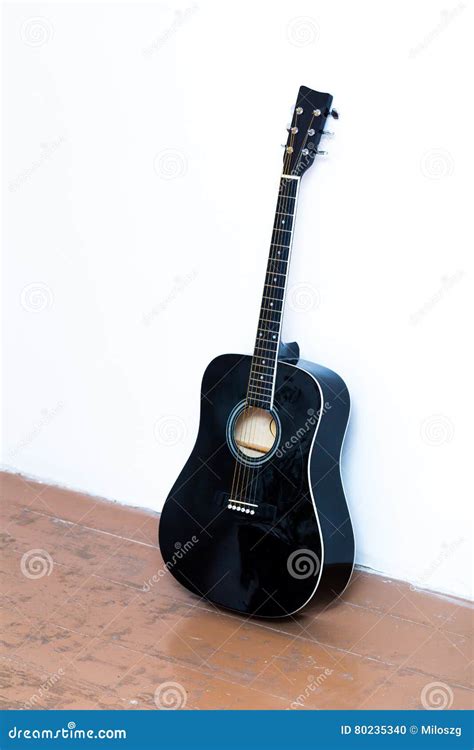 Acoustic Guitar Standing Next To White Wall Stock Photo Image Of