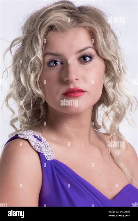 Beautiful Young Blond Woman Models Various Fashions In Studio Stock