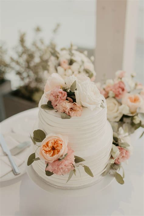 elegant white two tier wedding cake with fresh flowers and fondant stripes wedding cake fresh